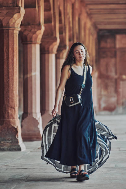 donna dell'asia orientale in vestito nero che danza con sciarpa traslucida tra le colonne del tempio antico - taj mahal mahal door temple foto e immagini stock