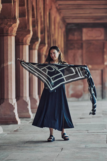 east asian woman in black dress dancing with translucent scarf among columns of ancient temple - taj mahal mahal door temple imagens e fotografias de stock