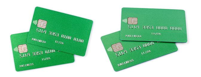 Two green credit cards isolated on white background.
