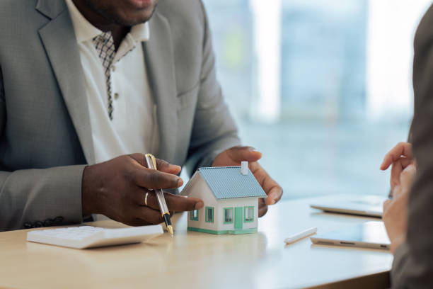 istock Real Estate Agent and client talking about Property insurance and security concept about house to client before sign contract 1660915804