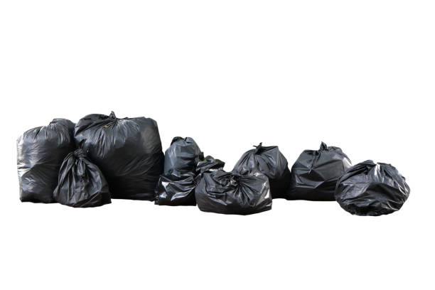 istock Several black trash bags are placed together isolated on white background with clipping path. 1660916944