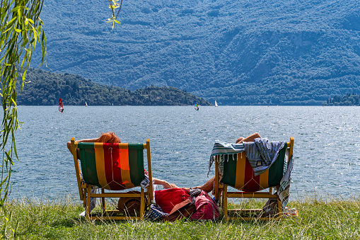 Couple relaxing on Lake Como beach
