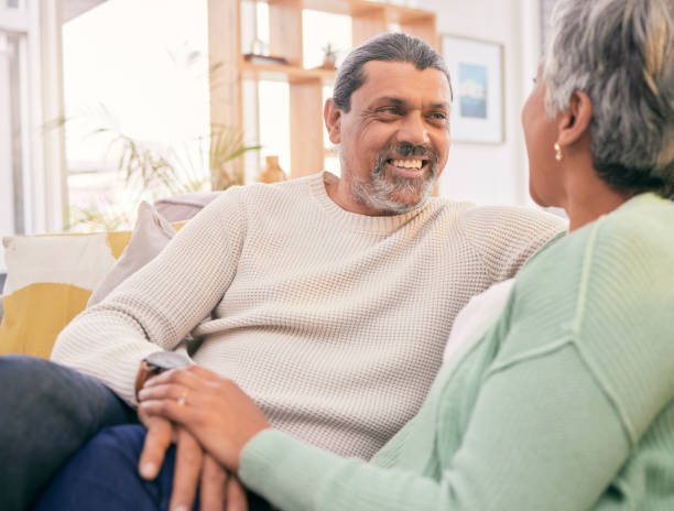 istock Happy, talking and mature couple on sofa for bonding, healthy relationship and connection. Marriage, love and man and woman relaxing on couch for discussion, conversation and chat in living room 1660930608
