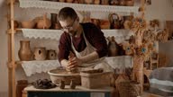 istock Working process in ceramic workshop. Crafting work concept. Man potter working 1660938940