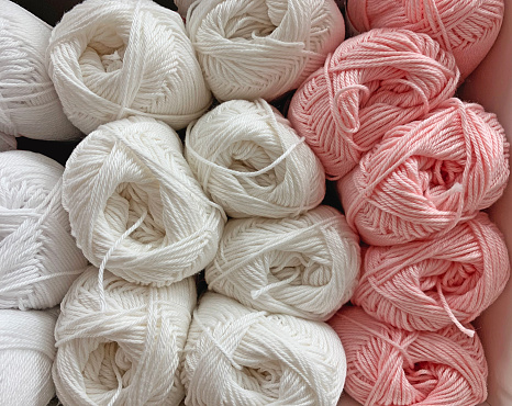 Colorful yarn for knitting as a background. Close-up, wool on the shelf in the store