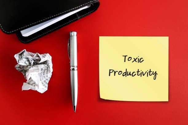 istock Pen notebook and crumpled with handwritten note TOXIC PRODUCTIVITY, means desire for productivity at all times, inability to stop working and take adequate time to rest and recharge 1660941122