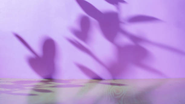 Empty wooden table for product presentation on an abstract purple background