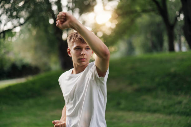 young man power pose. People emotions lifestyle concept. Mock up copy space. Showing biceps muscles