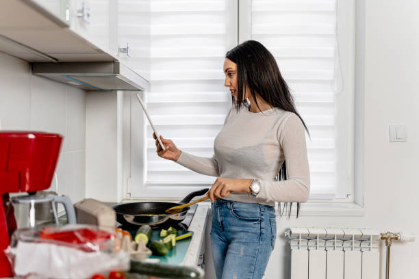 istock Woman Employs Digital Tablet for a Seamless Cooking Experience 1661003688