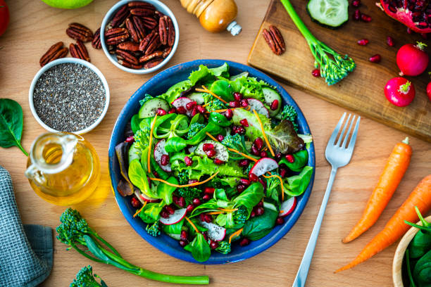istock Overhead view of a healthy fresh salad plate on dining table 1661012818