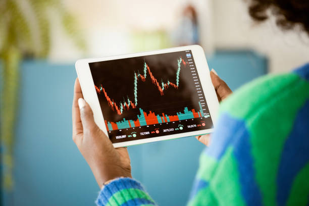 istock Woman watching stock charts 1661021807