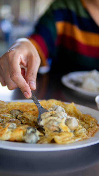 istock Close up women eating seafood 1661022035