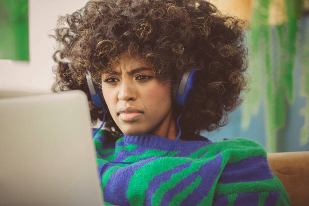 istock Young woman using laptop at home 1661022040
