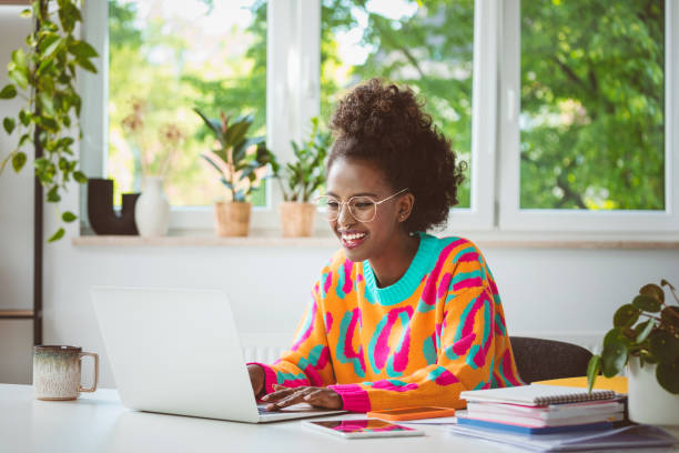 istock Young woman working at home, using laptop 1661024645