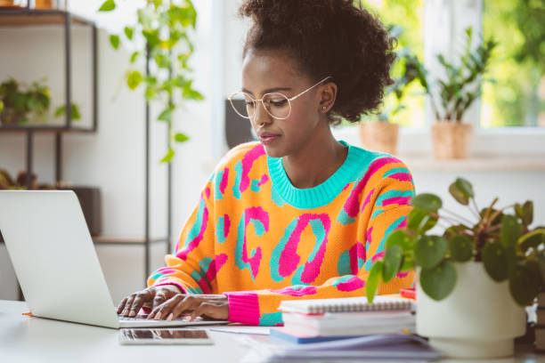 istock Young woman working at home, using laptop 1661025170
