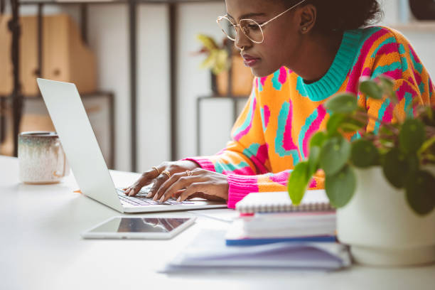 istock Young woman working at home, using laptop 1661025707