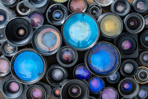 a lot of vintage camera lenses from the times of the ussr on a wooden background, closeup, top view - large aperture imagens e fotografias de stock