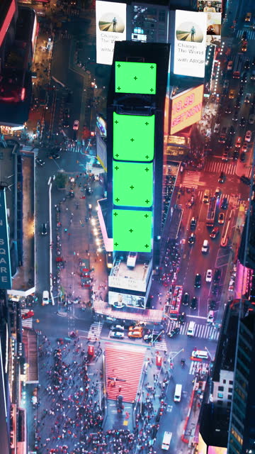 Vertical Screen: Helicopter Night Tour of New York City. Glowing Times Square with Green Screen Mock Up Advertising Templates and Tourists Enjoying Manhattan Nightlife and Admiring the Landmark