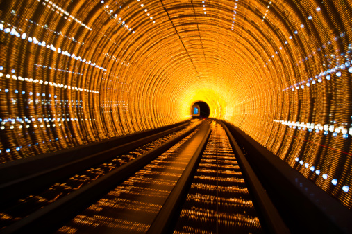 abstract image of light waves in deep tunnel. tunnel as seen from a train