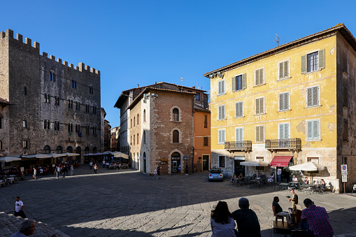 Massa Marittima, Italy - Sept 11, 2022: Garibaldi square and Palazzo del Podesta in Massa Marittima. Italy
