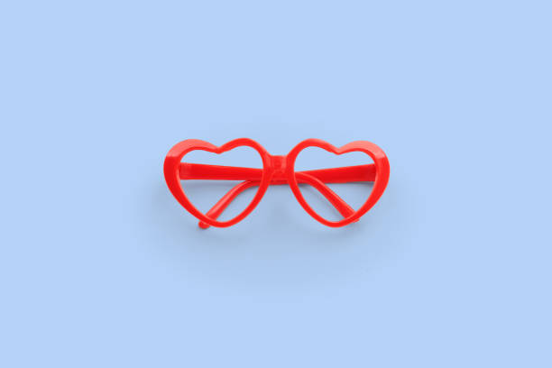 istock Red heart shaped sunglasses on blue background 1661071254
