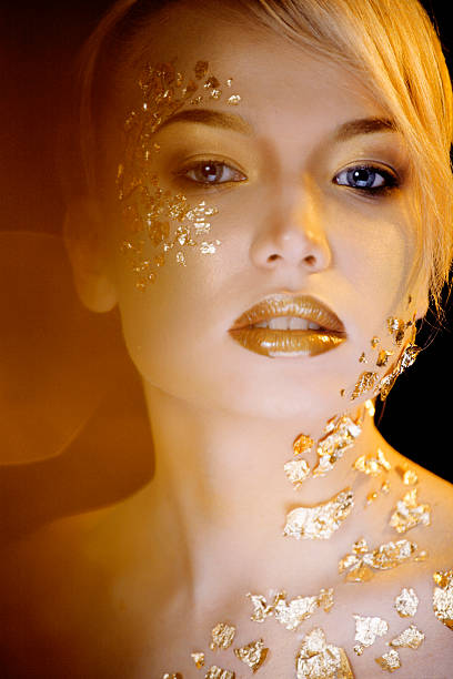 istock beauty blond woman with gold creative make up 166108545