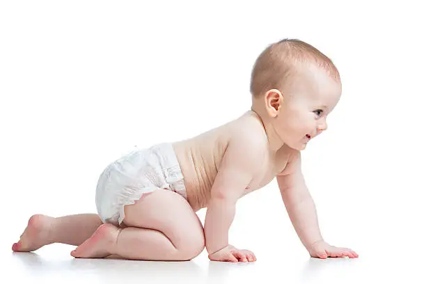 Photo of side view of pretty crawling baby girl