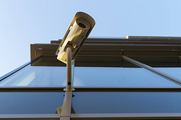 Security camera on the glass building stock photo