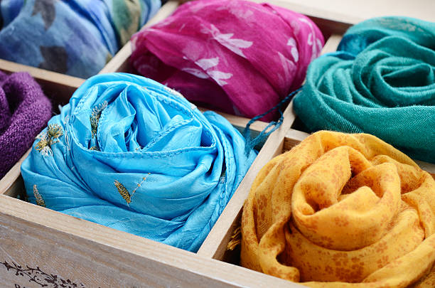 Set of colorful scarves in wooden box Vintage wooden box with different colorful scarves scarf stock pictures, royalty-free photos & images