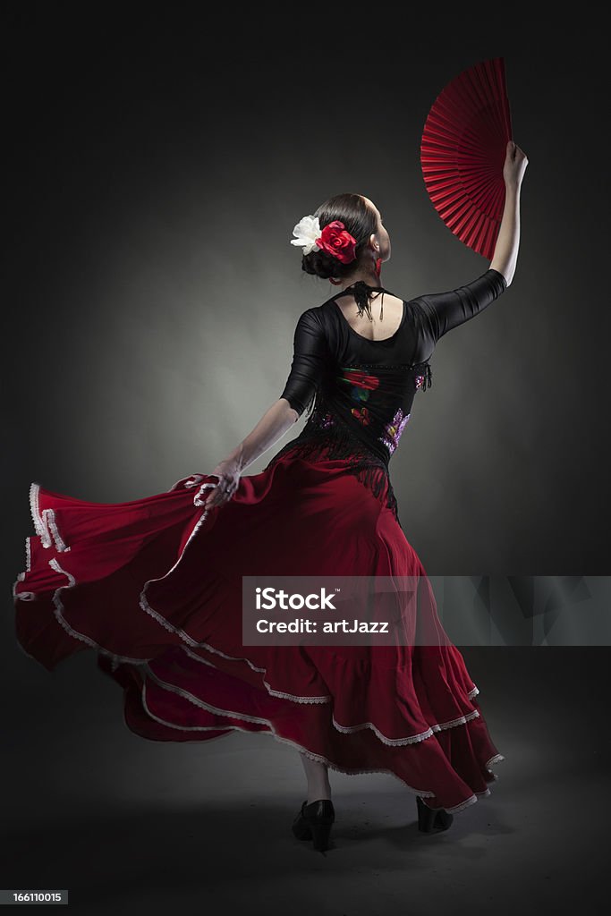 young woman dancing flamenco on black Flamenco Dancing Stock Photo