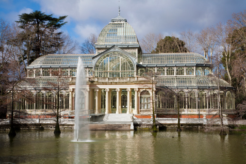 Vienna, Austria - 18 June 2019: Old greenhouse in public park by blue sky in Vienna, Austria