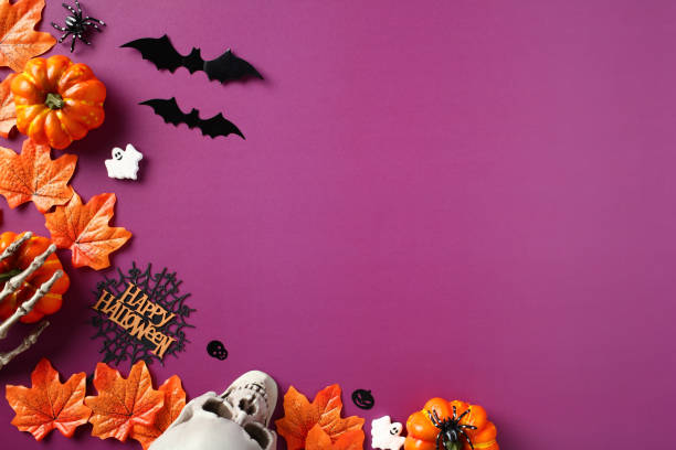 istock Happy Halloween holiday concept. Halloween decorations, bats, ghosts, maple leaves, skull on purple background. Halloween party invitation card mockup with copy space. Flat lay, top view, overhead 1661101638