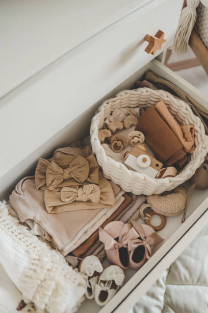 istock Dresser with clothes for a newborn, organizing storage 1661105422