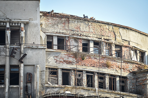 Big cracks on the facade of an old building in Bucharest