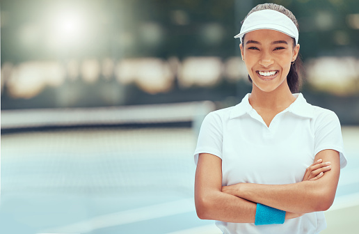 Tennis, sport and fitness with a sports woman on a court with her arms crossed outside for health and wellness. Training, exercise and fitness with a young female player ready for a game or match