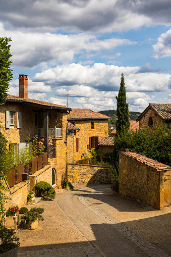 Street and houses in golden stones typical of this region of Beaujolais in the medieval town of Oingt