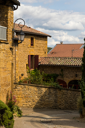 Street and houses in golden stones typical of this region of Beaujolais in the medieval town of Oingt