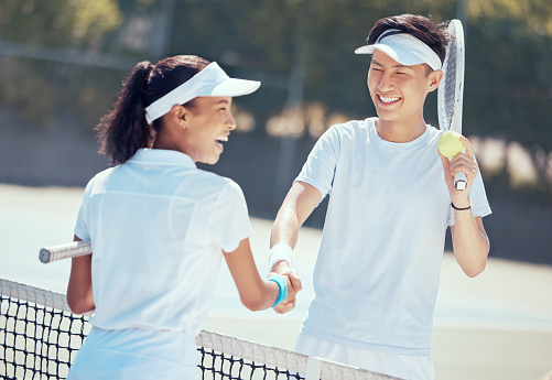 Tennis, handshake and teamwork with a health athlete or coach shaking hands on a sports court, game or match. Fitness, workout and training with friends saying thank you, well done or congratulation