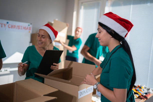 istock Volunteers work at Christmas in community donation center. 1661139397