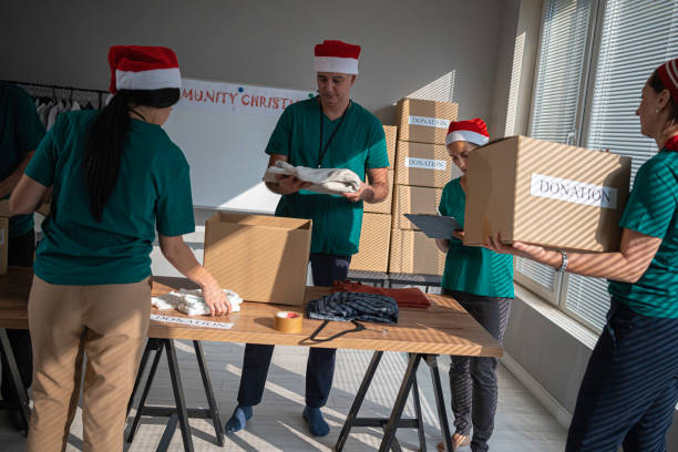 istock Volunteers work at Christmas in community donation center. 1661139409