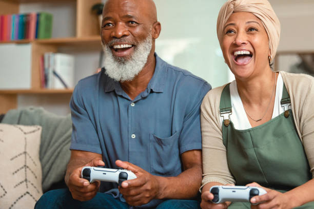istock Elderly Couple Playing Video Games on the Sofa 1661146061