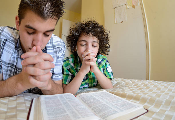 istock Young Family Praying 166115089
