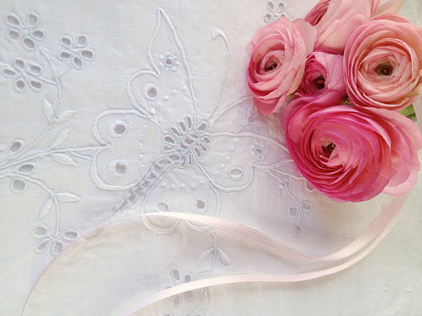 istock pink spring flowers on eyelet fabric 166115138