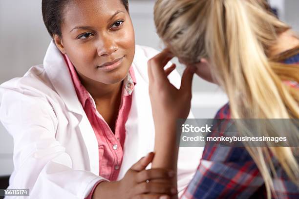 Teenage Girl Visits Doctors Office Suffering With Depression Stock Photo - Download Image Now