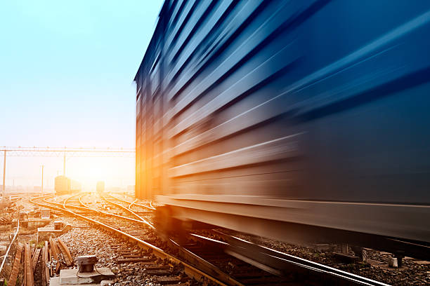 istock fast moving freight train, drawing out of the station 166115374