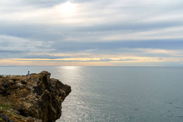 istock ocean rock formation calm sea and clouded sky 1661158857