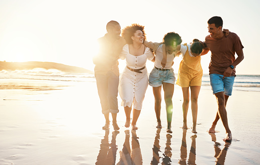 Summer, sunset and travel with friends at beach for freedom, support and diversity. Wellness, energy and happy with group of people walking by the sea for peace, adventure and vacation mockup