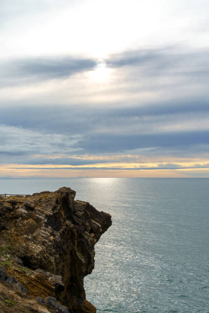 istock ocean rock formation calm sea and clouded sky 1661160536