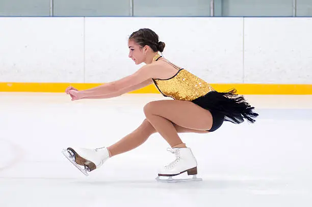 A young figure skater in a spin.