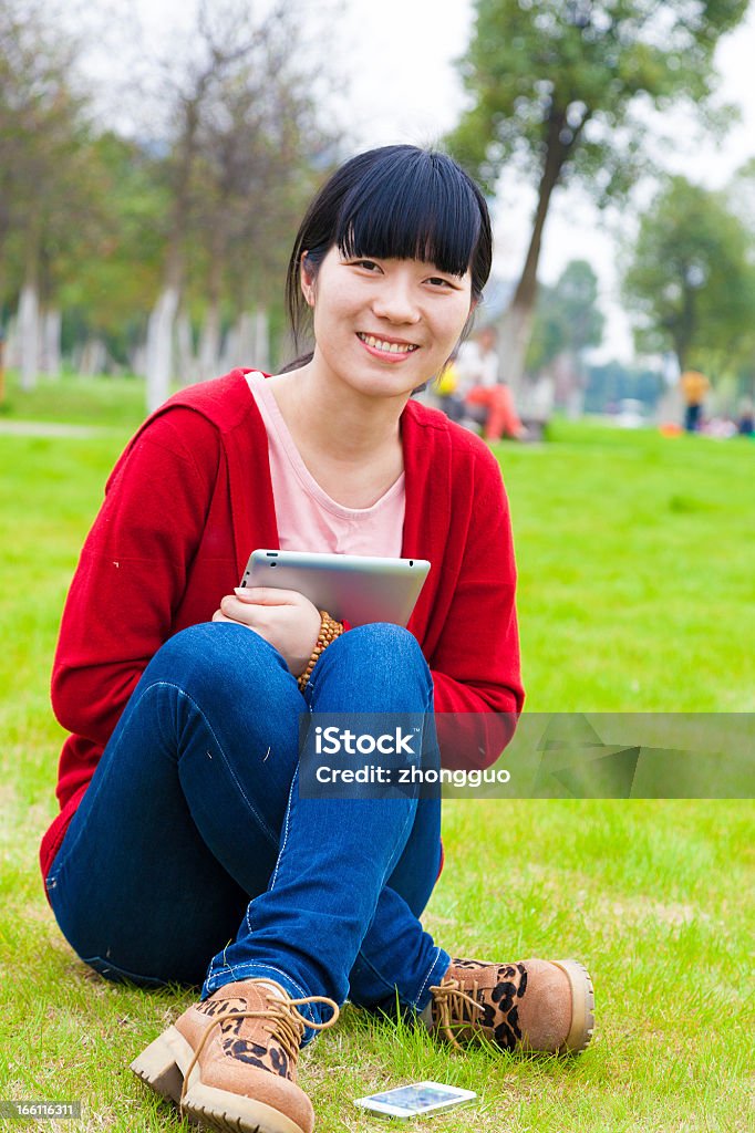 girl Girl on the lawn, using a Tablet PC Adult Stock Photo